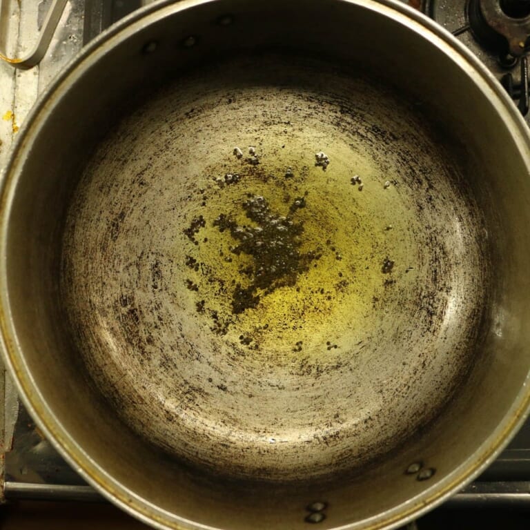 手順 1: 温めたフライパンでサラダ油を熱し、マスタードシードを加えます。