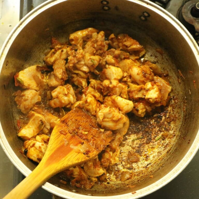 手順 6: ひと口大に切った鶏もも肉を加え、表面の色が変わるまで炒める。