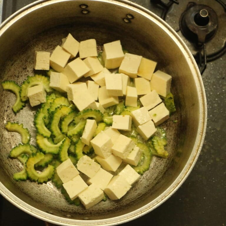 手順 1: フライパンで油を熱し木綿豆腐、ゴーヤを加えます。
