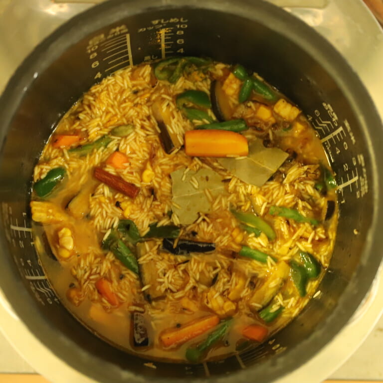 手順 5: フライパンに入っている材料を全て炊飯器に加えスパイスミックスA、B、水を加え、通常のご飯と同じように炊く。炊き上がったら