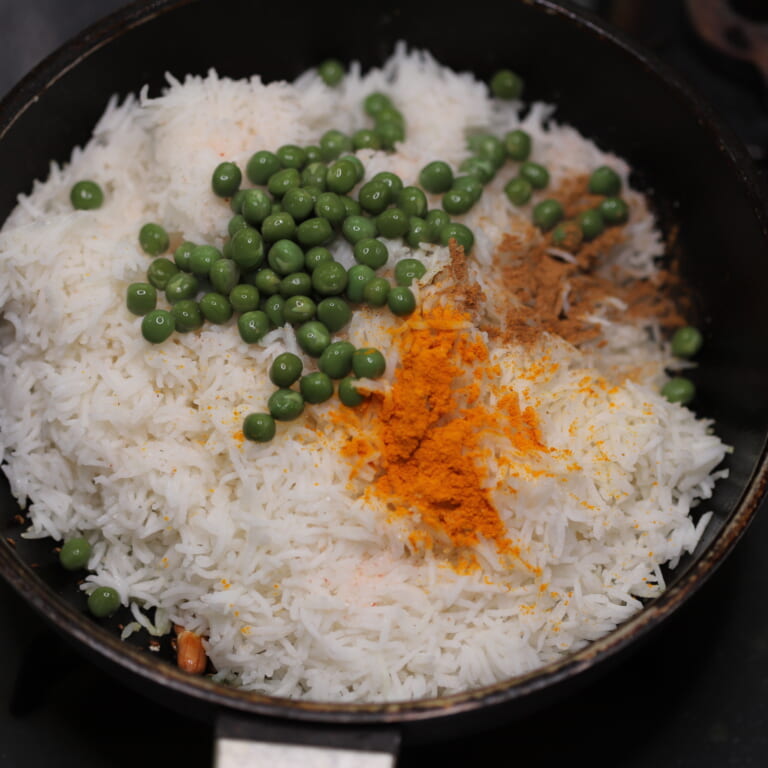手順 4: 一旦火を消し茹でておいたバスマティライスとグリーンピース、スパイスB、塩を加え混ぜる。