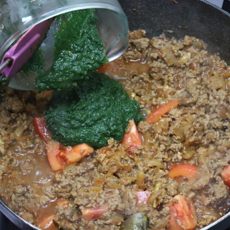 手順 6: 合いびき肉に火がはいったらトマト、１．のペースト、水を加え、一煮立ちさせたら弱火で１５分くらい煮込む。