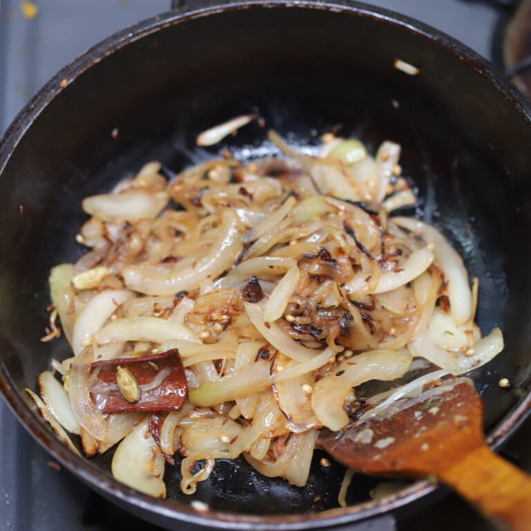 手順 2: 温めたフライパンに油を入れスパイスAを熱し、香りが立ってきたら玉ねぎを加えしっかりと飴色になるまで炒める。