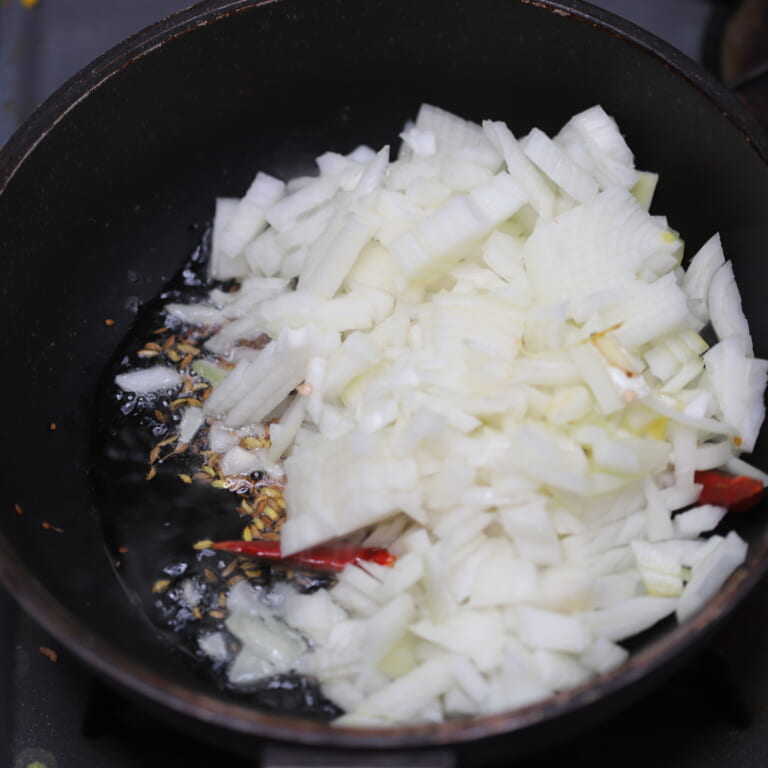 手順 2: 鍋に油を熱しスパイスBを炒め、細かい泡が出てきたら玉ねぎを加えて炒める。