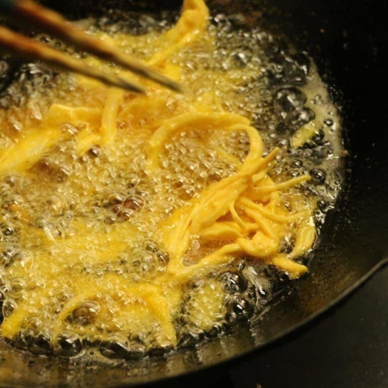 手順 2: 揚げ油を中温位まで熱し、新玉ねぎに衣をつけじっくりと揚げる。