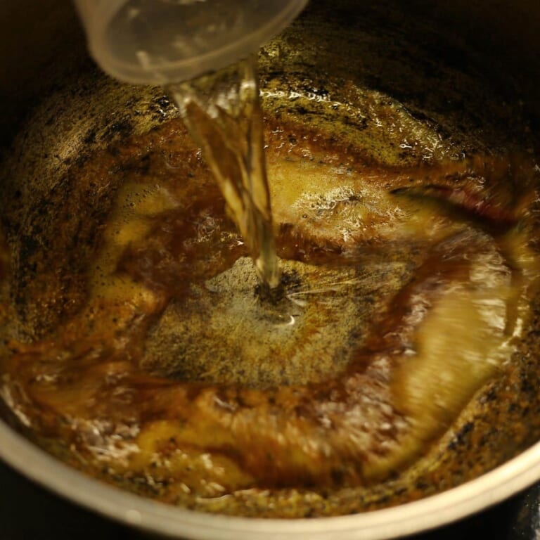 手順 3: ココナッツが薄茶色になり香りがたってきたら水を加える。