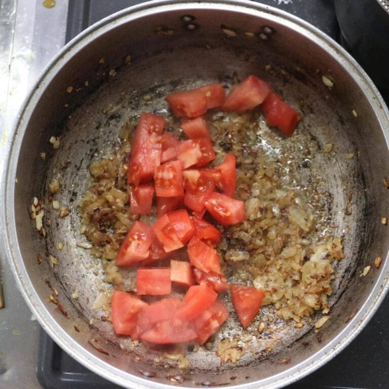 手順 6: 香りがたってきたらトマトを加え、水分が飛ぶまでしっかり炒める。
