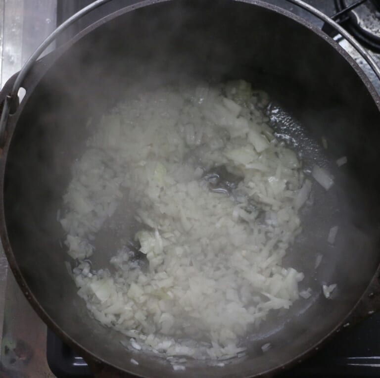 手順 5: 厚手の鍋に油を加え、玉ねぎを飴色になるまで炒める。