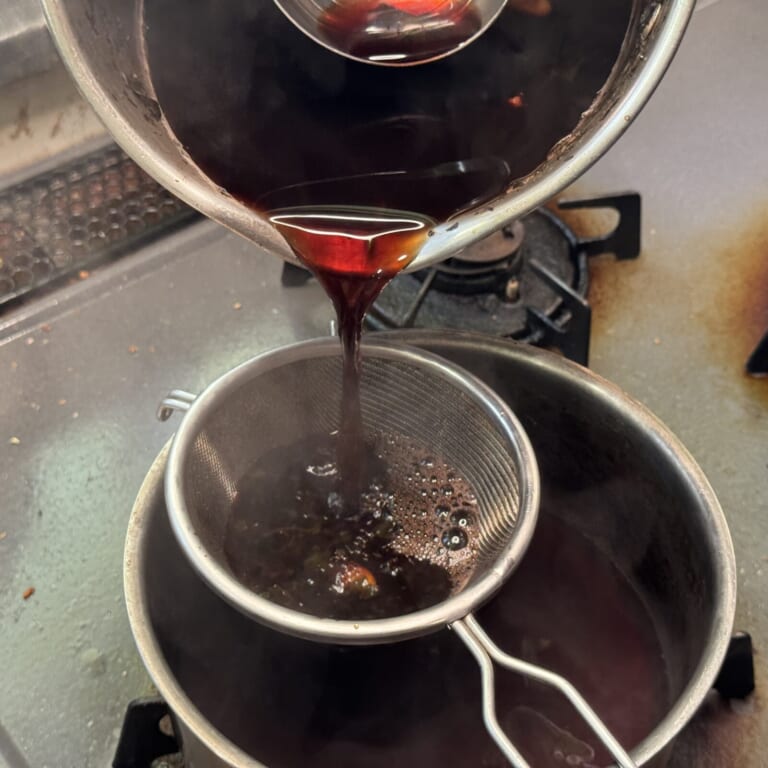 手順 5: 濃いピンク色になったら茶漉しで濾す。