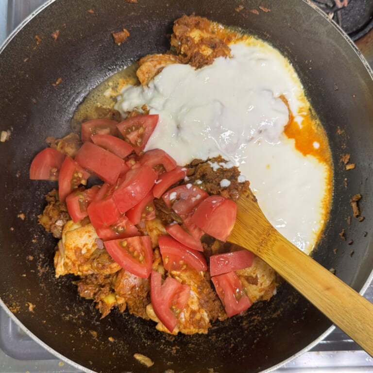 手順 3: 鶏肉を加え表面に火が入ったらトマト、ヨーグルトを加え炒め合わせる。